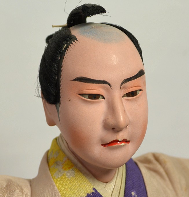 Japanese antique doll of a samurai in coutr attire, 1900's