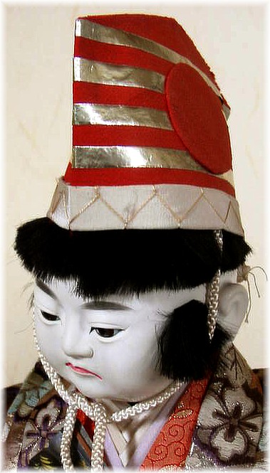 japanese antique doll of a boy with high striped hat