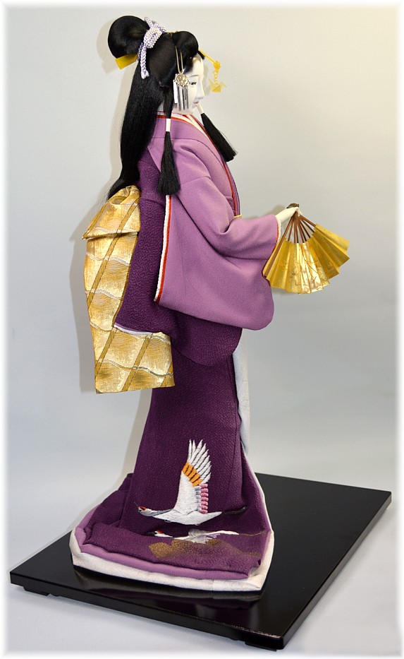 japanese doll of a long hair beauty dancing with folding fan
