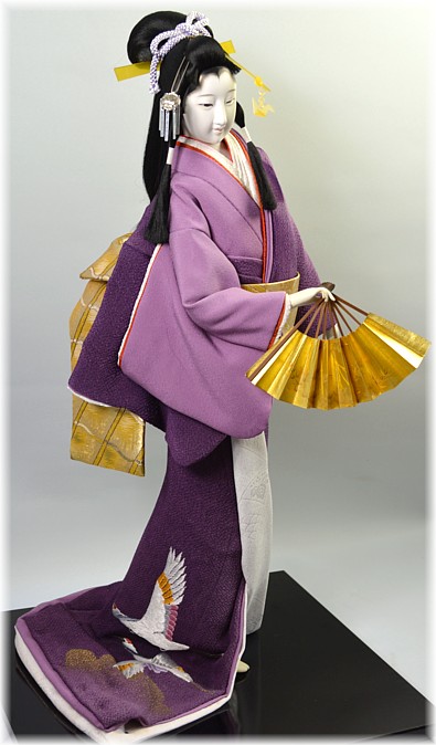 japanese doll of a beauty dancing with folding fan